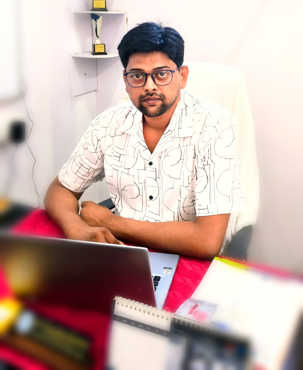Dr. Chandan Kumar at his desk at SL Dental Care